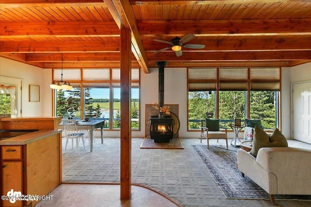 25925 Williamson Ln, Kasilof, AK 99610 - sunroom / solarium with beamed ceiling, plenty of natural light, and a wood stove