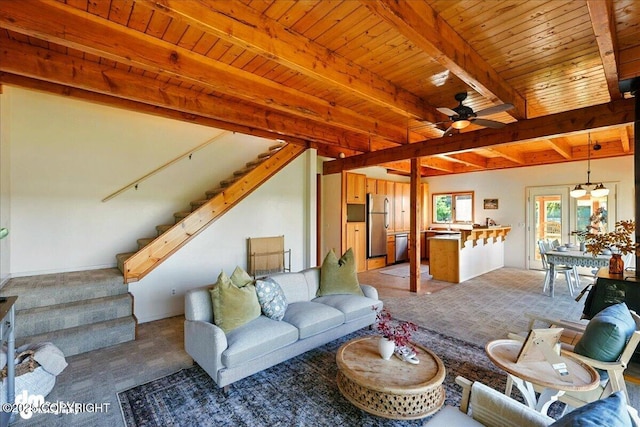 25925 Williamson Ln, Kasilof, AK 99610 - living area featuring light colored carpet, stairway, a ceiling fan, and a wooden ceiling with exposed beams