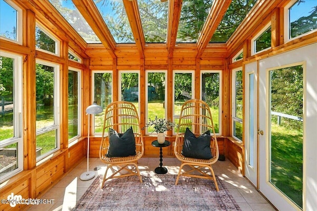 25925 Williamson Ln, Kasilof, AK 99610 - sunroom / solarium featuring french doors, tile patterned floors, vaulted ceiling, a skylight, and wood walls