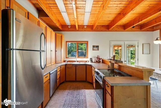 25925 Williamson Ln, Kasilof, AK 99610 - kitchen featuring stainless steel appliances, a peninsula, and a wooden ceiling with exposed beams