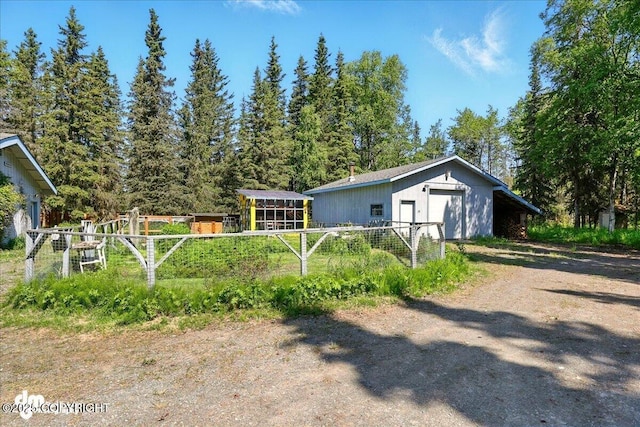 25925 Williamson Ln, Kasilof, AK 99610 - view of property exterior with a garage and an outbuilding