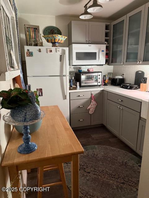 1217 Madsen Ave, Kodiak, AK 99615 - kitchen featuring gray cabinets, tasteful backsplash, a toaster, light countertops, and white appliances