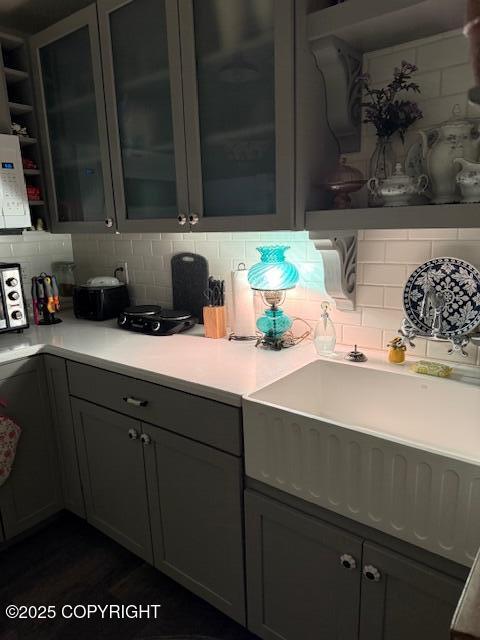 1217 Madsen Ave, Kodiak, AK 99615 - kitchen featuring light countertops, tasteful backsplash, white microwave, and gray cabinets