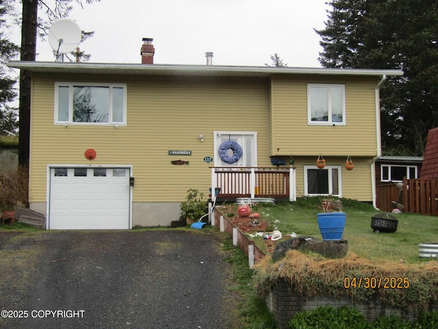 1217 Madsen Ave, Kodiak, AK 99615 - split foyer home with a garage, a chimney, a front yard, and aphalt driveway