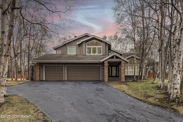 craftsman-style home featuring driveway, a shingled roof, and a garage