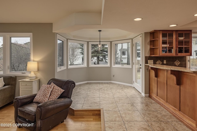 sitting room featuring light tile patterned floors, baseboards, and recessed lighting