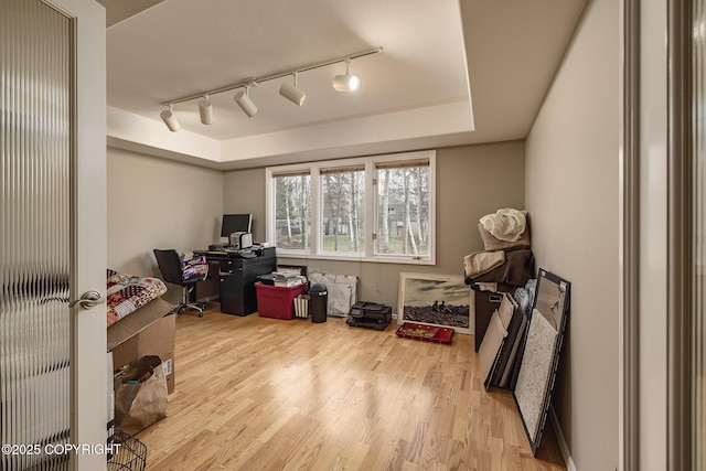 office area with rail lighting and wood finished floors