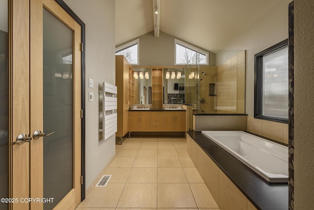 bathroom featuring a tile shower, tile patterned floors, vaulted ceiling with beams, visible vents, and a bath