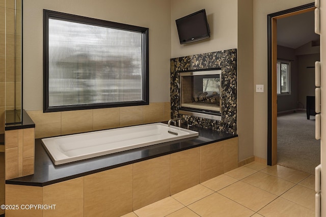bathroom featuring tile patterned floors and a bath