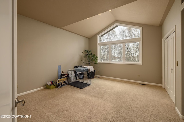 miscellaneous room featuring visible vents, baseboards, vaulted ceiling, and carpet