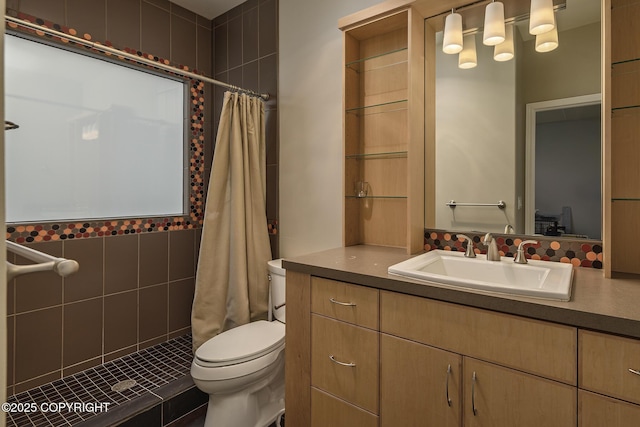 full bath featuring toilet, a tile shower, and vanity