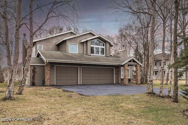 view of front of house featuring an attached garage, a chimney, a front lawn, and aphalt driveway