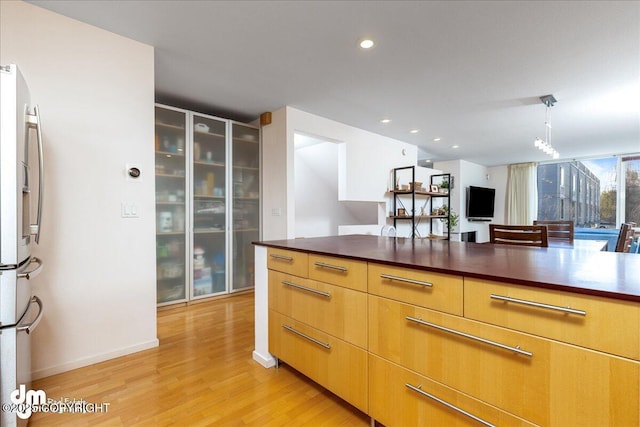 5201 E Northern Lights Blvd # 3N, Anchorage, AK 99508 - kitchen featuring dark countertops, stainless steel fridge with ice dispenser, light wood-style flooring, and recessed lighting