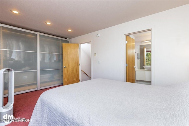 5201 E Northern Lights Blvd # 3N, Anchorage, AK 99508 - bedroom featuring connected bathroom, carpet floors, and recessed lighting