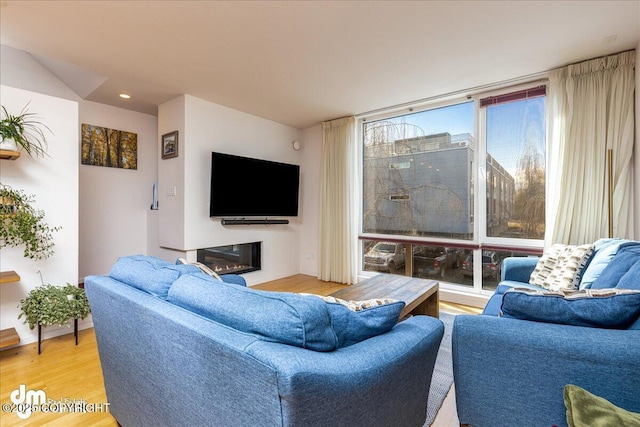 5201 E Northern Lights Blvd # 3N, Anchorage, AK 99508 - living room featuring a glass covered fireplace and wood finished floors