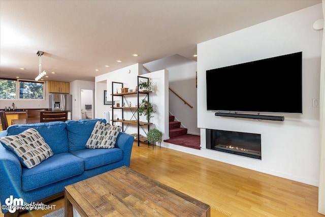 5201 E Northern Lights Blvd # 3N, Anchorage, AK 99508 - living area featuring light wood-style flooring, stairs, baseboards, and recessed lighting