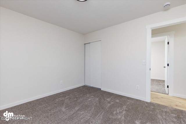 1523 Demeure Pl, Anchorage, AK 99508 - unfurnished bedroom featuring carpet, a closet, and baseboards