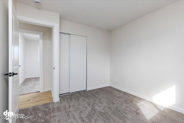 1523 Demeure Pl, Anchorage, AK 99508 - unfurnished bedroom featuring carpet, baseboards, and a closet