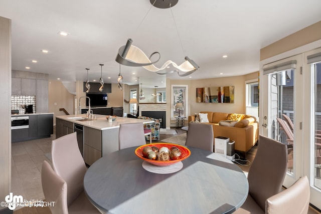 1741 W 15th Ave, Anchorage, AK 99501 - dining space featuring recessed lighting, light tile patterned flooring, and a fireplace