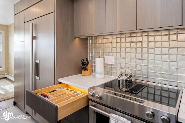 1741 W 15th Ave, Anchorage, AK 99501 - kitchen featuring built in refrigerator, modern cabinets, stainless steel electric stove, and tasteful backsplash