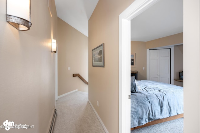 1741 W 15th Ave, Anchorage, AK 99501 - corridor with baseboards, baseboard heating, carpet flooring, and an upstairs landing