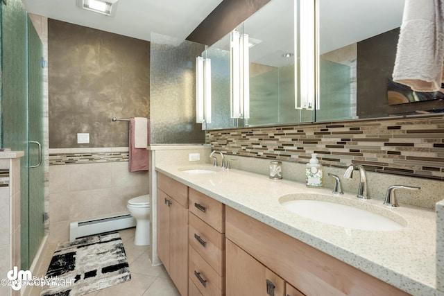 1741 W 15th Ave, Anchorage, AK 99501 - bathroom featuring tile walls, tile patterned floors, a sink, and baseboard heating