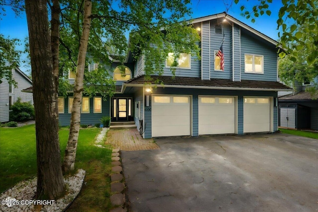 4200 Endeavor Cir, Anchorage, AK 99515 - view of front of property with a garage, asphalt driveway, and a front lawn