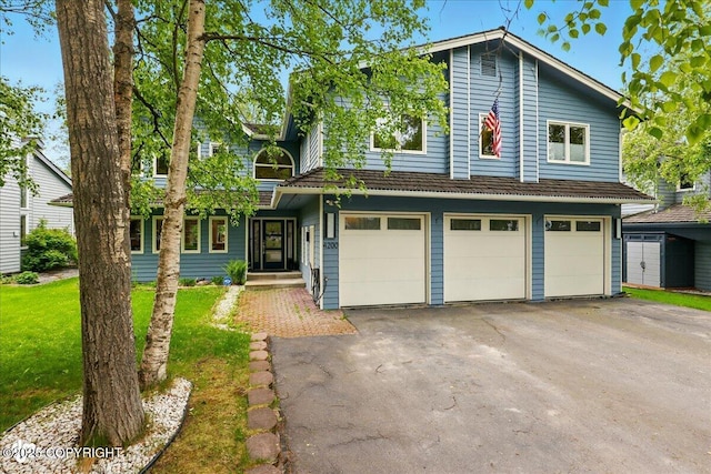 4200 Endeavor Cir, Anchorage, AK 99515 - view of front facade with asphalt driveway, a garage, and a front yard