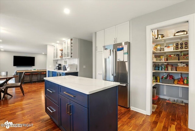 4200 Endeavor Cir, Anchorage, AK 99515 - kitchen featuring freestanding refrigerator, blue cabinetry, dark wood finished floors, white cabinets, and light countertops