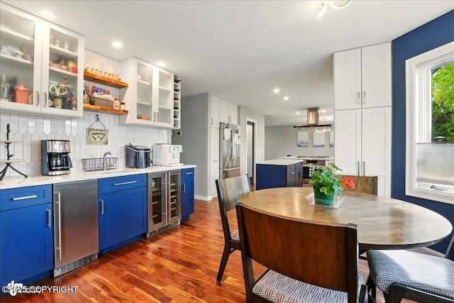 4200 Endeavor Cir, Anchorage, AK 99515 - kitchen featuring wine cooler, blue cabinetry, white cabinets, stainless steel refrigerator, and recessed lighting
