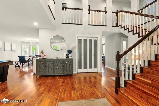 4200 Endeavor Cir, Anchorage, AK 99515 - foyer entrance with wood finished floors, stairway, a towering ceiling, and baseboards