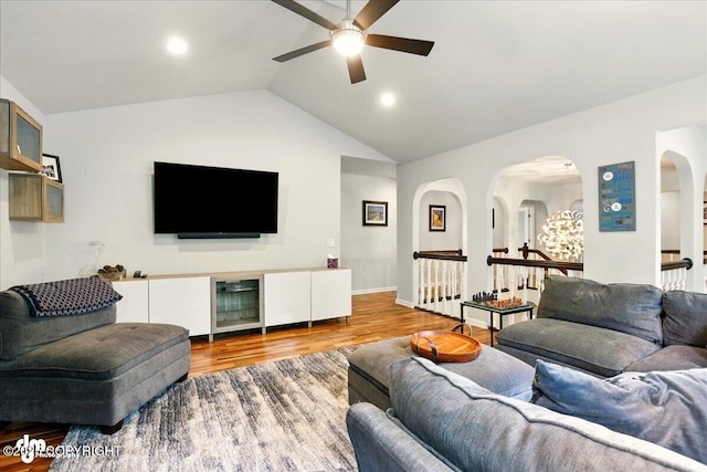 4200 Endeavor Cir, Anchorage, AK 99515 - living area with ceiling fan, wine cooler, arched walkways, vaulted ceiling, and wood finished floors