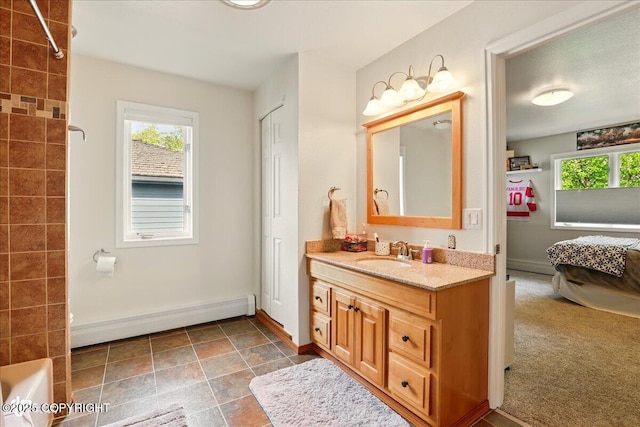 4200 Endeavor Cir, Anchorage, AK 99515 - bathroom with a baseboard radiator, vanity, plenty of natural light, and baseboards