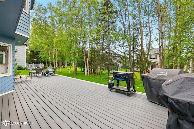 4200 Endeavor Cir, Anchorage, AK 99515 - wooden terrace with a lawn, view of scattered trees, and a fire pit