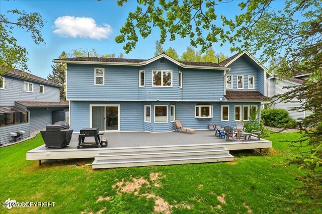 4200 Endeavor Cir, Anchorage, AK 99515 - rear view of house featuring a lawn and a wooden deck
