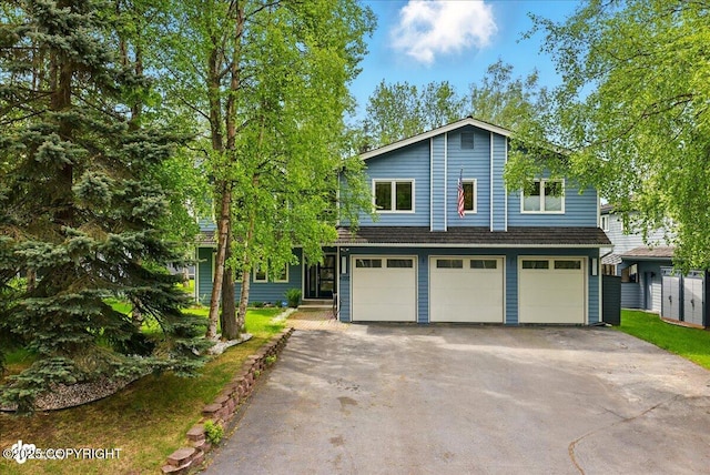 4200 Endeavor Cir, Anchorage, AK 99515 - view of front of house featuring a garage and asphalt driveway