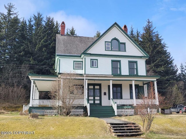 1 Fort Seward Dr, Haines, AK 99827 - view of front of property featuring a chimney, a porch, and a front yard