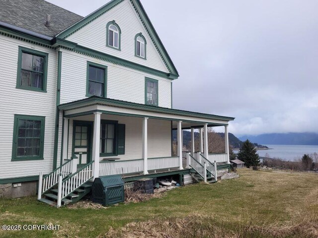 1 Fort Seward Dr, Haines, AK 99827 - view of front of home with a porch, a front lawn, and a water view