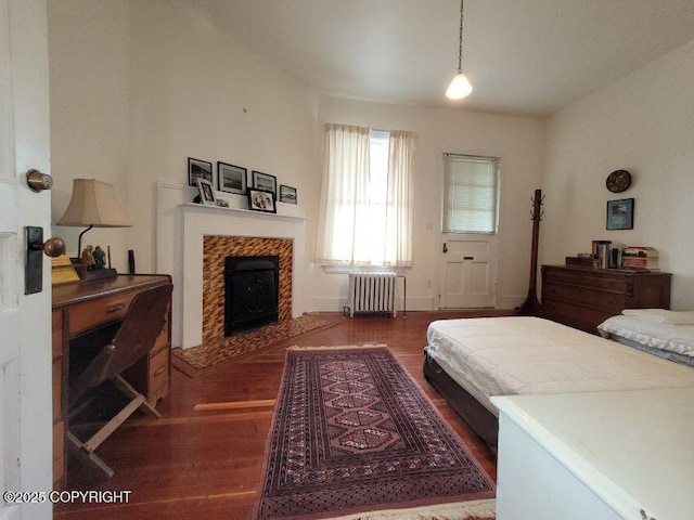 1 Fort Seward Dr, Haines, AK 99827 - bedroom featuring a fireplace, radiator heating unit, and wood finished floors