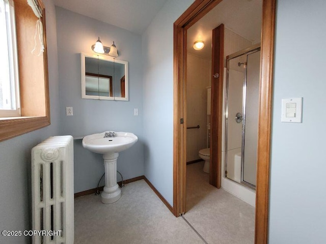 1 Fort Seward Dr, Haines, AK 99827 - full bath with a shower stall, toilet, radiator heating unit, and baseboards