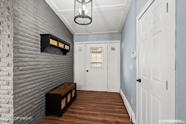 doorway to outside featuring wood finished floors, a baseboard heating unit, and vaulted ceiling
