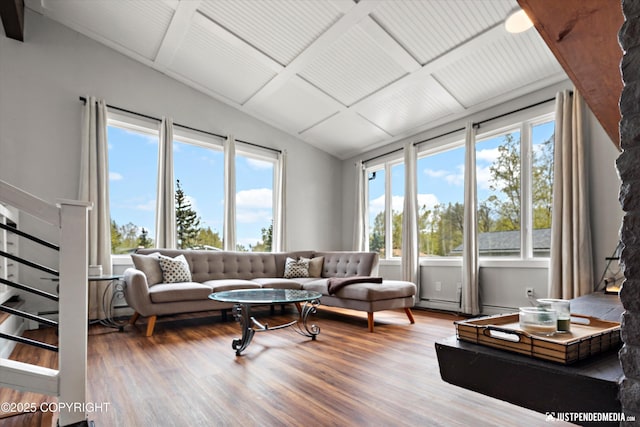living area with wood finished floors, plenty of natural light, and stairway