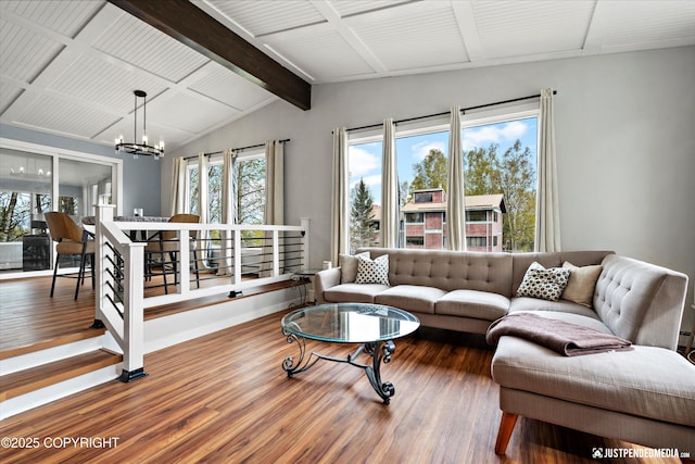 living room with wood finished floors, a chandelier, and baseboards