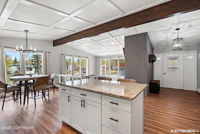 kitchen with a chandelier, dark wood-style floors, and white cabinets