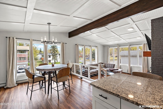 dining area featuring dark wood-type flooring, a chandelier, and baseboard heating