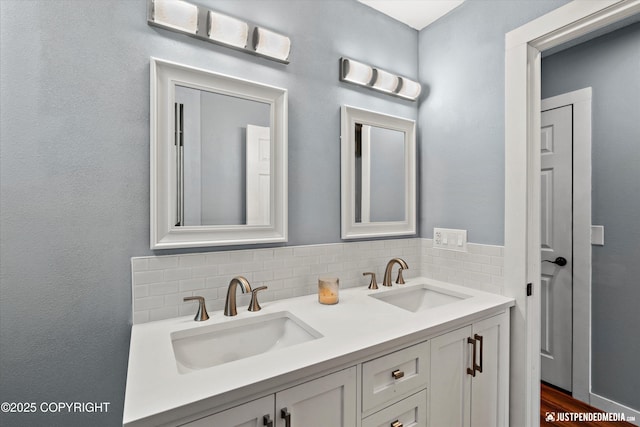 bathroom featuring tasteful backsplash and double vanity