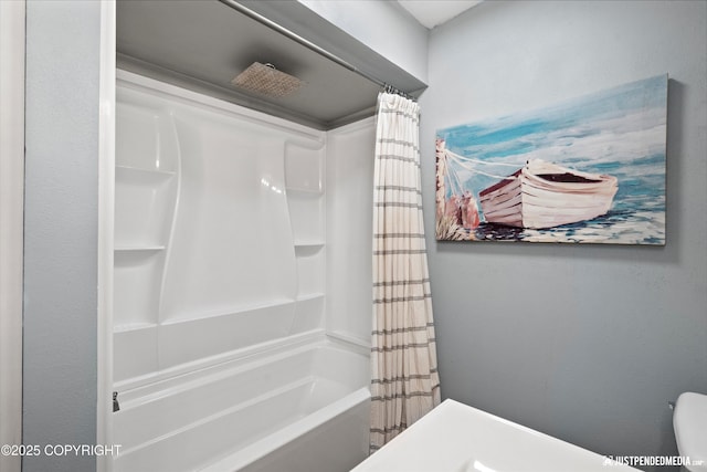bathroom with shower / tub combo and toilet