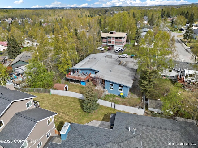aerial perspective of suburban area with a forest