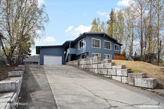 view of front of house featuring concrete driveway and a garage