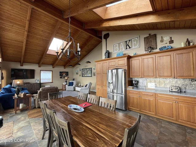 dining room featuring an inviting chandelier, wooden ceiling, beam ceiling, stone finish flooring, and a skylight